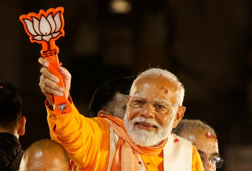 India's Prime Minister Narendra Modi shows the Bharatiya Janata Party (BJP) symbol during a roadshow as part of an election campaign, in Varanasi, India, May 13, 2024. REUTERS/Adnan Abidi