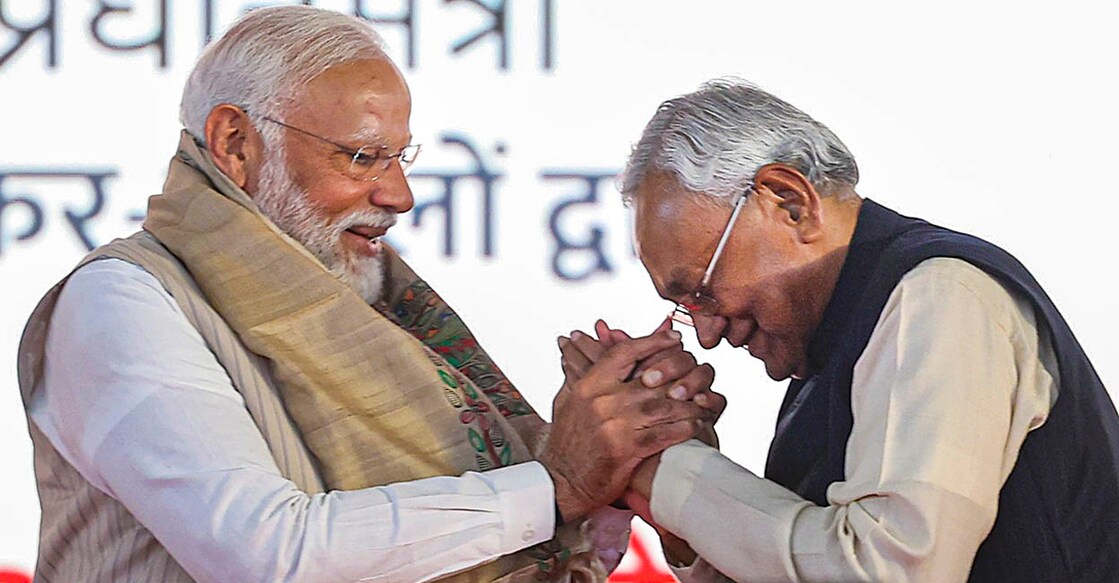 **EDS: IMAGE VIA PMO** Begusarai: Prime Minister Narendra Modi being greeted by Bihar Chief Minister Nitish Kumar during the inauguration and foundation stone laying ceremony of various development projects, in Begusarai, Saturday, March 2, 2024. (PTI Photo) (PTI03_02_2024_000319A)