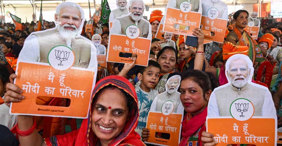 Supporters of Bharatiya Janata Party (BJP) hold cut-outs of India's Prime Minister Narendra Modi during an election campaign rally in New Delhi on May 18, 2024, ahead of the fifth phase of polling in the ongoing country's general election. (Photo by Arun SANKAR / AFP)