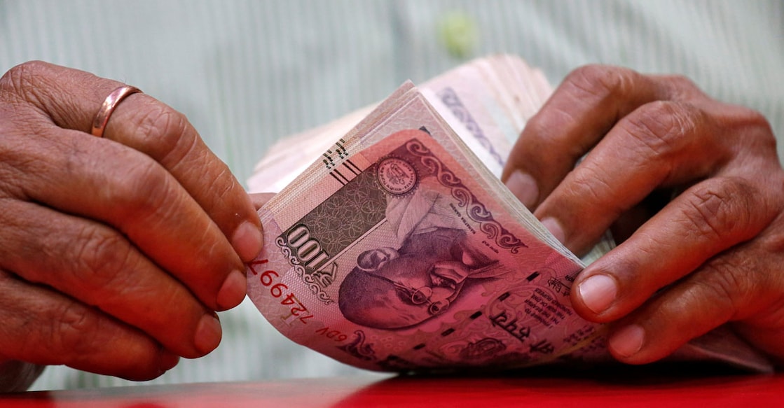INDIA-MARKETS/RUPEE A man counts Indian currency notes inside a shop in Mumbai, India, August 13, 2018. REUTERS/Francis Mascarenhas