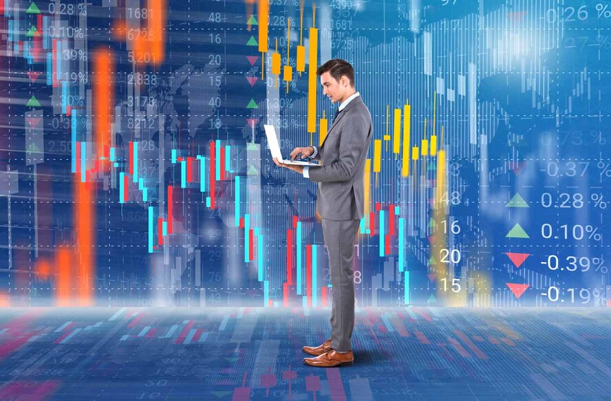 Businessman holding laptop in front of virtual interface of stock market data background