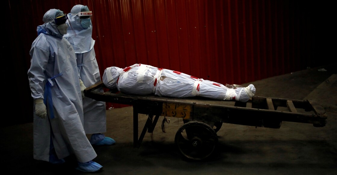 HEALTH-CORONAVIRUS/INDIA Health workers carry the body of a man who died due to the coronavirus disease (COVID-19) for his cremation at a crematorium in New Delhi, India, June 4, 2020. REUTERS/Adnan Abidi TPX IMAGES OF THE DAY