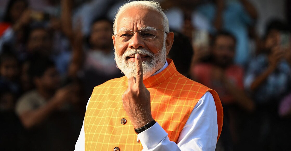 INDIA-POLITICS-VOTE India's Prime Minister Narendra Modi, leader of the ruling Bharatiya Janata Party (BJP) displays his inked marked finger after casting his ballot at a polling booth at Ranip, Ahmedabad on May 7, 2024. (Photo by Sajjad HUSSAIN / AFP)