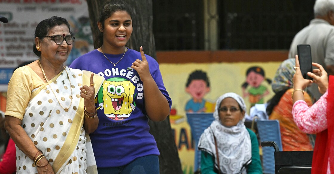 Voters display their ink marked fingers after casting their ballots at a polling station during the fourth phase of voting in India’s general election, at Panvel in Maharashtra state on May 13, 2024. (Photo by Indranil Mukherjee / AFP)