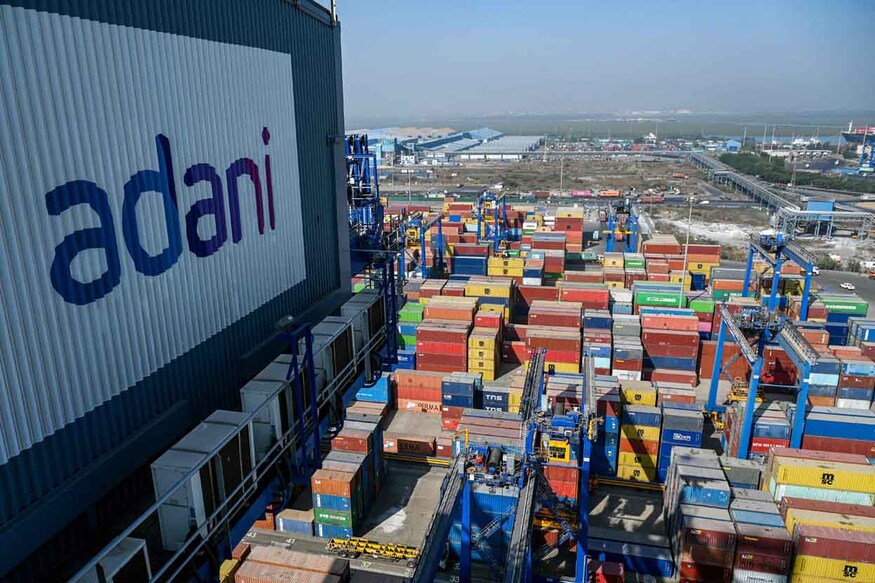 This photograph taken on January 11, 2024, shows a general view of the Adani Group owned Mundra Port in Mundra. Deep in the desert along the border with Pakistan, India's most controversial billionaire is building the world's largest renewable energy park as he races to future-proof his coal-linked fortune. Gautam Adani's ports-to-airports, media and energy empire -- which critics say has benefited from his links with Indian Prime Minister Narendra Modi -- made him for a brief time in 2022 the world's second-richest man, with a $154 billion fortune. (Photo by Punit PARANJPE / AFP) / TO GO WITH 'India-Adani-energy’, FOCUS by Bhuvan BAGGA