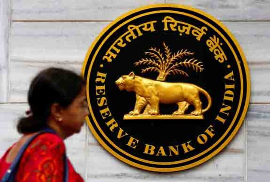 FILE PHOTO: A woman walks past the Reserve Bank of India (RBI) head office in Mumbai, India, December 6, 2017. REUTERS/Shailesh Andrade/File Photo