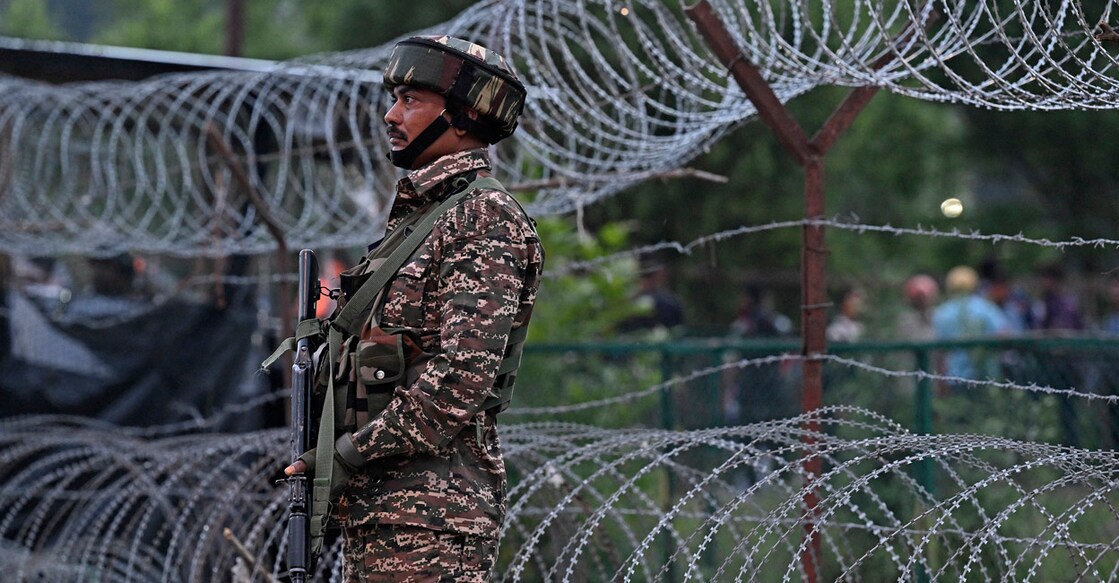 An Indian security service member keeps watch as Hindu devotees begin their pilgrimage to the cave shrine of Amarnath from a base camp in Pahalgam on June 29, 2024. (Photo by TAUSEEF MUSTAFA / AFP)