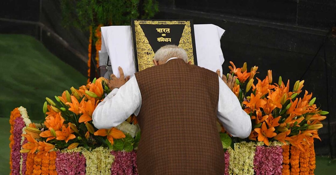 INDIA-POLITICS Indian designated Prime Minister Narendra Modi pays his respects to the Indian constitution during a National Democratic Alliance (NDA) meeting at the central hall of the parliament, in New Delhi on May 25, 2019. Modi has been formally elected as leader of the Bhartiya Janta Party (BJP) led National Democratic Alliance (NDA) during the meeting. (Photo by Prakash SINGH / AFP)