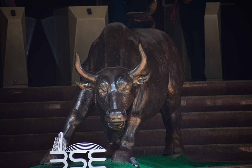 2424267917 Mumbai, India - 10 October 2021, Picture of a bull and logo of Bombay stock exchange. Share market, Dalal street, rise, fall, index, fund, profit, loss, companies, bear, BSE, NSE, SEBI, law, broker.