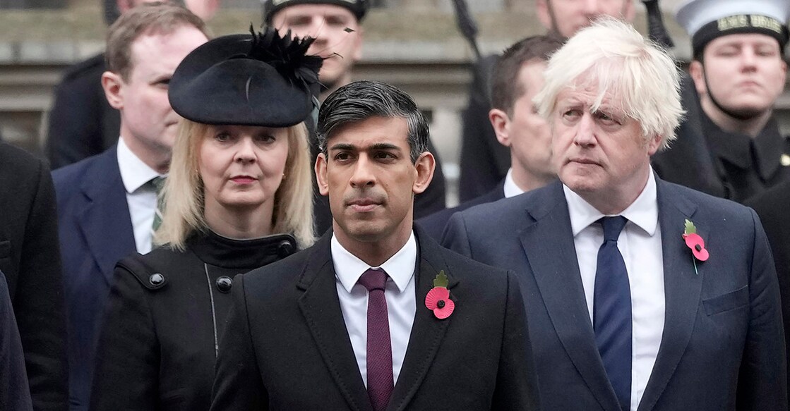 Britain's Prime Minister Rishi Sunak (C), holds a wreath as he stands with former Prime Ministers Liz Truss (L) and Boris Johnson (R), as they attend the National Service of Remembrance at the Cenotaph on Whitehall in central London, on November 12, 2023. Remembrance Sunday is an annual commemoration held on the closest Sunday to Armistice Day, November 11, the anniversary of the end of the First World War and services across Commonwealth countries remember servicemen and women who have fallen in the line of duty since WWI. (Photo by Kin Cheung / POOL / AFP)