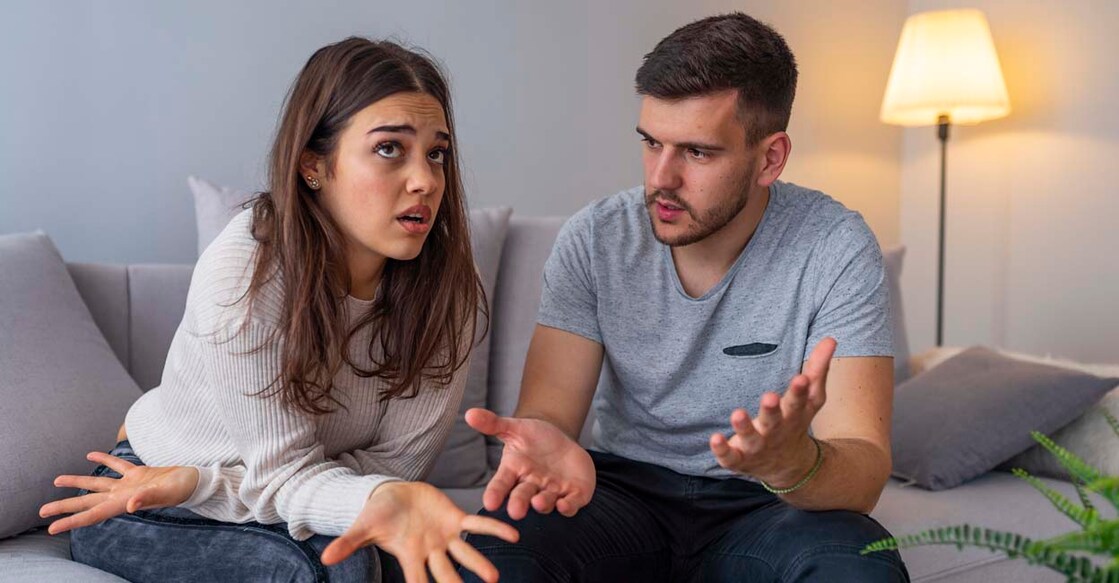 Couples are angry with love issues. Not understanding each other in family problems or infidelity . Couple having argument on the couch at home in the living room