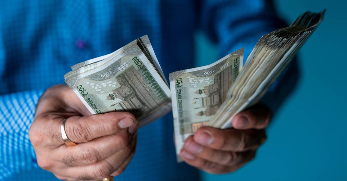 Indian business man counting newly launched indian five hundred rupees. Money counting background concept with copy space.