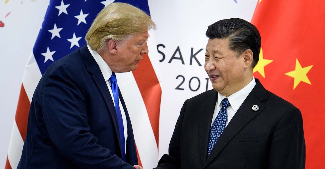 China's President Xi Jinping (R) shakes hands with US President Donald Trump before a bilateral meeting on the sidelines of the G20 Summit in Osaka on June 29, 2019. (Photo by Brendan Smialowski / AFP)