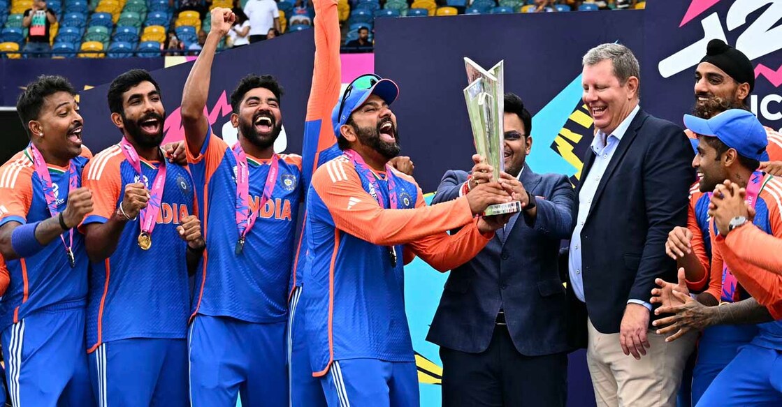 India's captain Rohit Sharma (4th L) and Jay Shah (4th R), Secretary of the Board of Control for Cricket in India (BCCI), accept the trophy from Greg Barclay (3rd R), chairman of the International Cricket Council (ICC), as Team India celebrates after winning the ICC men's Twenty20 World Cup 2024 final cricket match between India and South Africa at Kensington Oval in Bridgetown, Barbados, on June 29, 2024. (Photo by CHANDAN KHANNA / AFP)