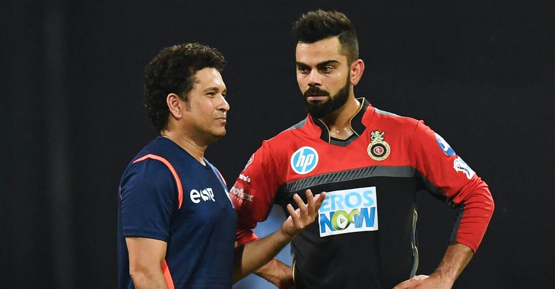 Virat Kohli and Sachin Tendulkar ഐപിഎൽ മത്സരത്തിനിടെ വിരാട് കോലിയും സച്ചിൻ തെൻഡുൽക്കറും. (Photo by PUNIT PARANJPE / AFP)