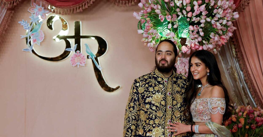 Anant Ambani Radhika Merchant, son of businessman Mukesh Ambani, poses with his wife Radhika Merchant on the red carpet during the sangeet ceremony at Jio World Centre, Mumbai. REUTERS/Francis Mascarenhas