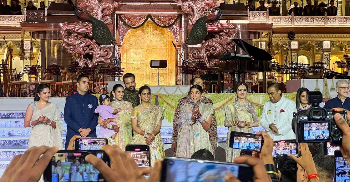 The Ambani Wedding Newly married Radhika Merchant Ambani speaks during the second day of her and Anant Ambani's wedding reception ‘Mangal Utsav’, organised for the Reliance employees and media, in Mumbai. Other members of the Ambani and Merchant families are also seen. (PTI Photo/Kunal Patil) (PTI07_15_2024_000274A)
