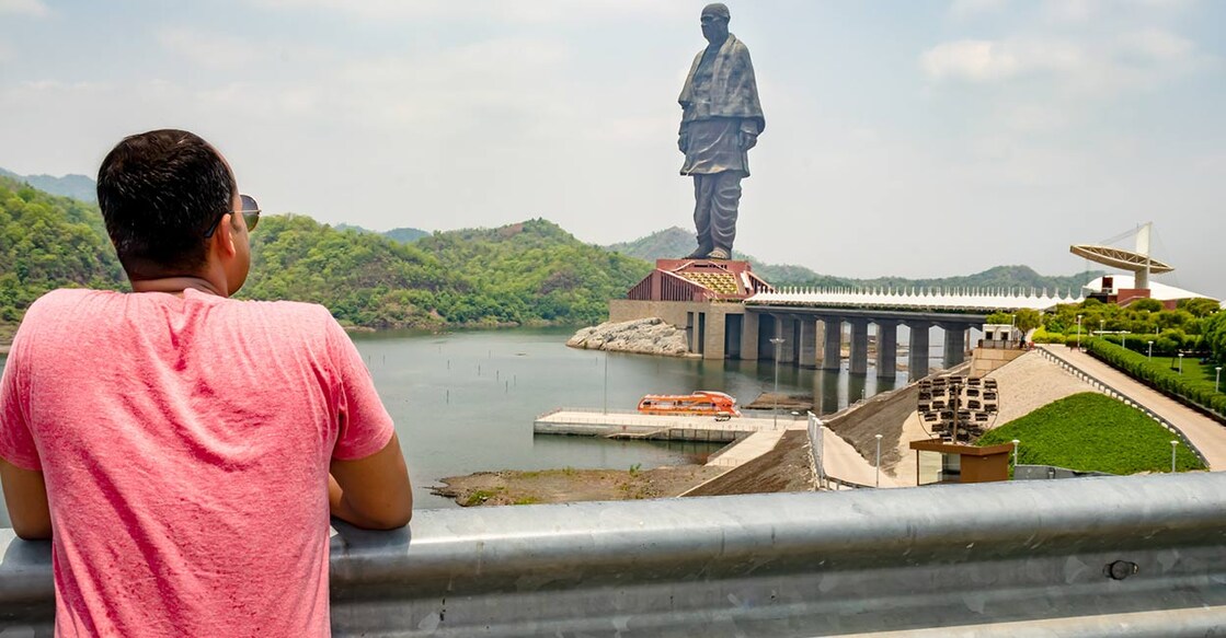 Man looking at the statue of unity with bright dramatic sky at day from different angle image is taken at vadodra gujrat. Image Credit : bambam kumar jha/istockphotos.com