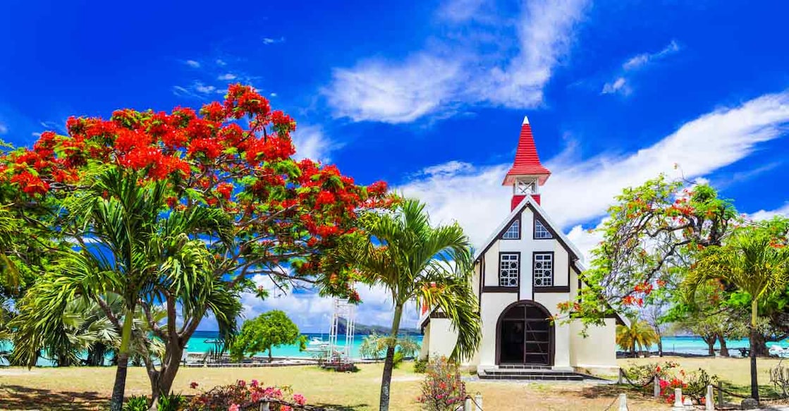 534624316 Scenery of beautiful Mauritius island - Red church on the beach with blooming flamboyant tree. Image Credit: leoks/shutterstock